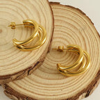 Créoles triple anneaux finition or design empilé moderne